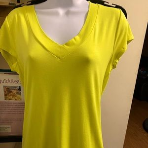Very bright yellow V neck T-shirt that is a staple for chill days.